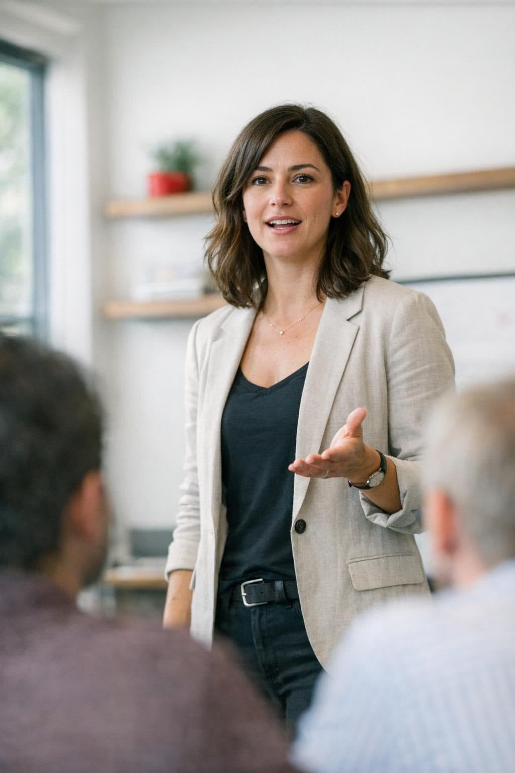 A woman presenting confidently to her team